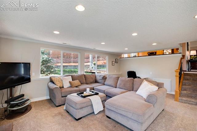 691 Gilcrest Road Colorado Springs, CO 80906 - Photo 20 of 28 Relaxing downstairs family room and wood burning fire place