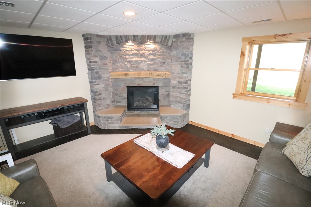 10582 Irvin Road Creston, OH 44217 - Photo 18 of 47 Living room in the walk out basement with a stone fireplace