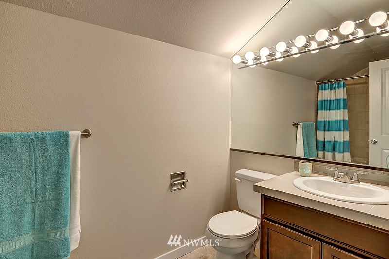 4304 181st Street Southeast Bothell, WA 98012 - Photo 14 of 18 a bathroom with a sink a toilet and mirror