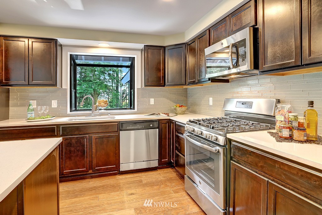 4304 181st Street Southeast Bothell, WA 98012 - Photo 4 of 18 a kitchen with stainless steel appliances granite countertop a stove a sink and a microwave