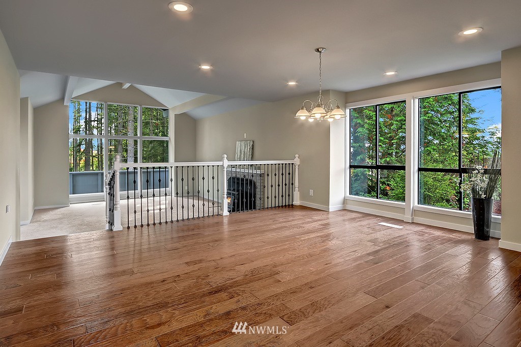 4304 181st Street Southeast Bothell, WA 98012 - Photo 5 of 18 a view of an empty room with wooden floor and a window