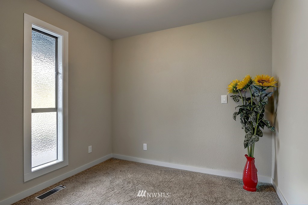 4304 181st Street Southeast Bothell, WA 98012 - Photo 8 of 18 an empty room with windows