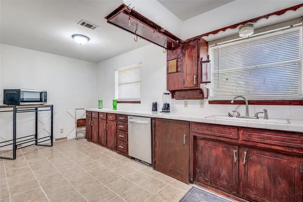 a kitchen with stainless steel appliances granite countertop a sink and cabinets