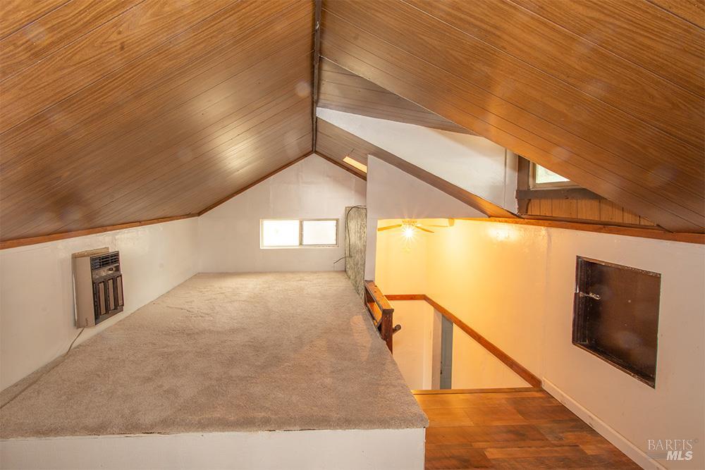 18089 Riverside Drive Sonoma, CA 95476 - Photo 11 of 14 a view of a hallway with wooden floor and staircase