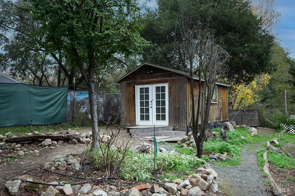 18089 Riverside Drive Sonoma, CA 95476 - Photo 3 of 14 a front view of a house with garden