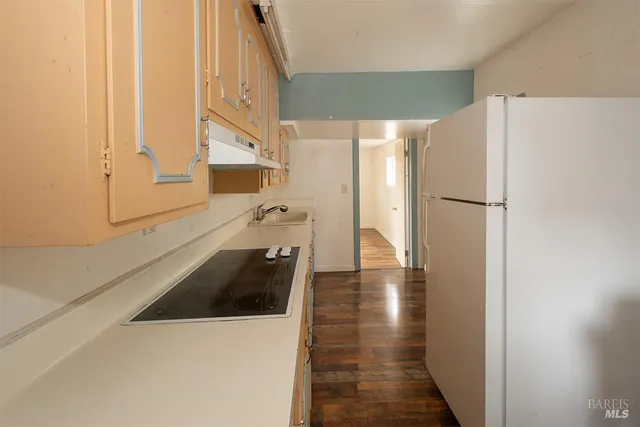 a kitchen with a refrigerator and a sink