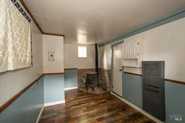 a kitchen with cabinets and wooden floor
