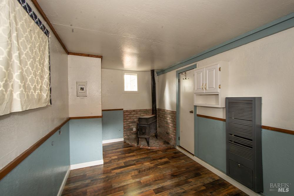 18089 Riverside Drive Sonoma, CA 95476 - Photo 9 of 14 a kitchen with cabinets and wooden floor