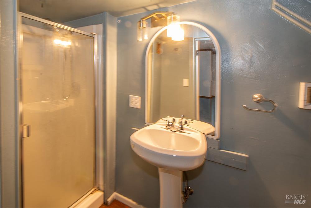 18089 Riverside Drive Sonoma, CA 95476 - Photo 10 of 14 a bathroom with a sink and a mirror