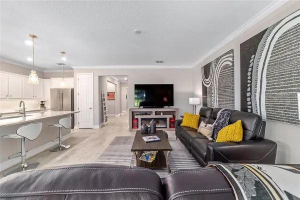 a kitchen with stainless steel appliances granite countertop a table chairs sink refrigerator and microwave