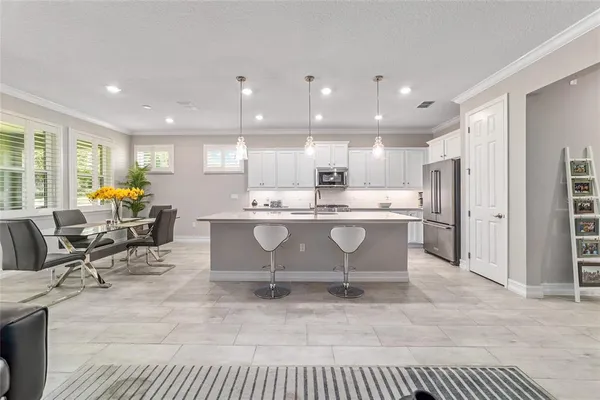 a kitchen with stainless steel appliances a sink a stove cabinets and a kitchen island
