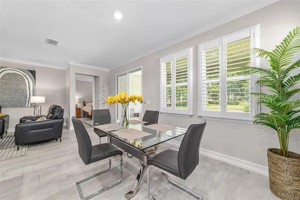 a living room with furniture kitchen and a table