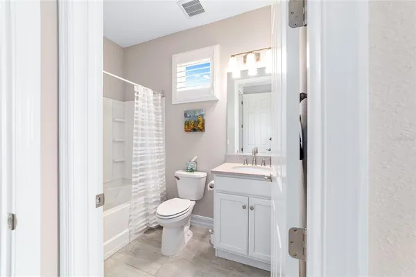 a view of a patio with table and chairs and potted plants
