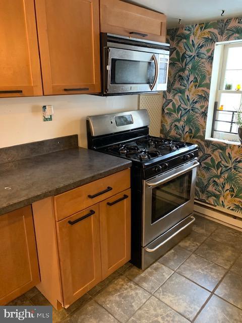 615 South Rose Street Baltimore, MD 21224 - Photo 3 of 11 a kitchen with stainless steel appliances granite countertop a stove a sink and a microwave