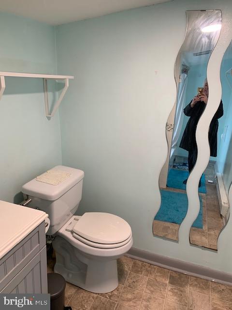 615 South Rose Street Baltimore, MD 21224 - Photo 8 of 11 a white toilet sitting next to a bathroom sink and vanity