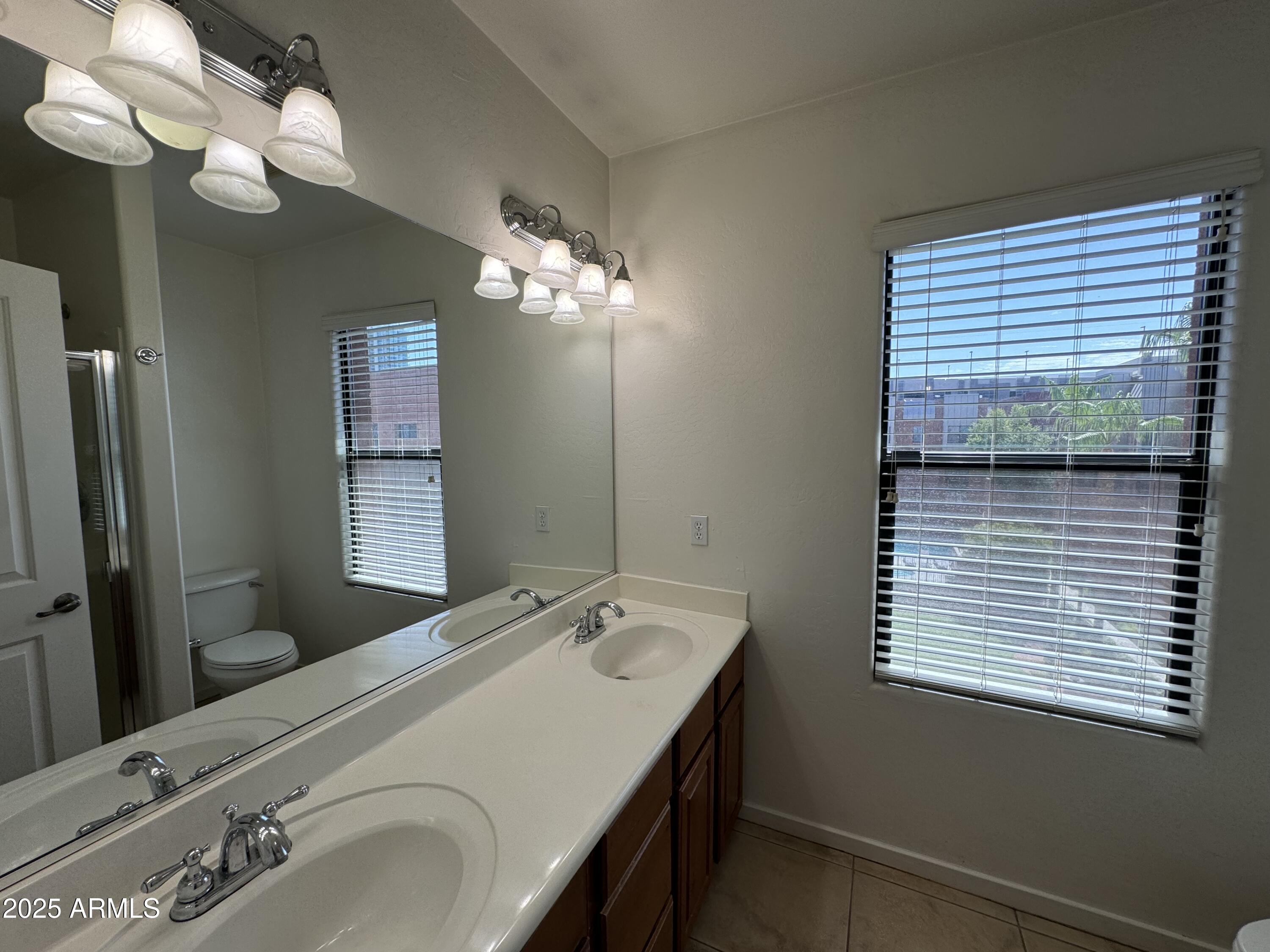 305 South Wilson Street, Unit 111 Tempe, AZ 85281 - Photo 28 of 48 a bathroom with a sink and a mirror