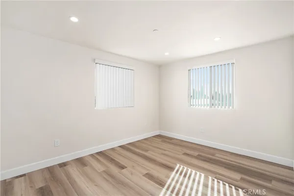 a view of a livingroom with wooden floor and white walls