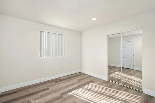 a view of a room with wooden floor and closet