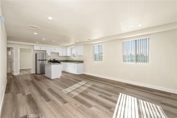 a kitchen with stainless steel appliances granite countertop a refrigerator and a stove top oven