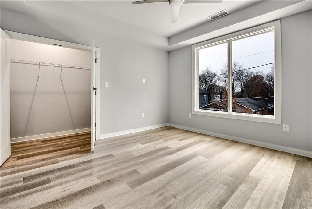 569 Middle Street Southwest Atlanta, GA 30310 - Photo 15 of 35 an empty room with wooden floor and windows