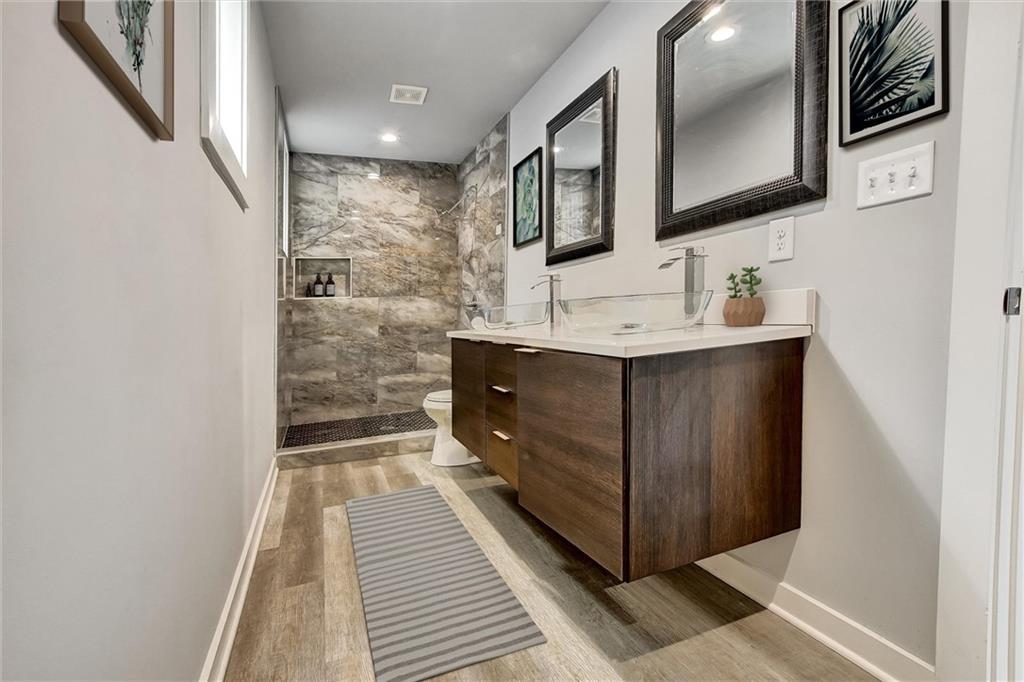 569 Middle Street Southwest Atlanta, GA 30310 - Photo 24 of 35 a bathroom with a sink a mirror and a shower