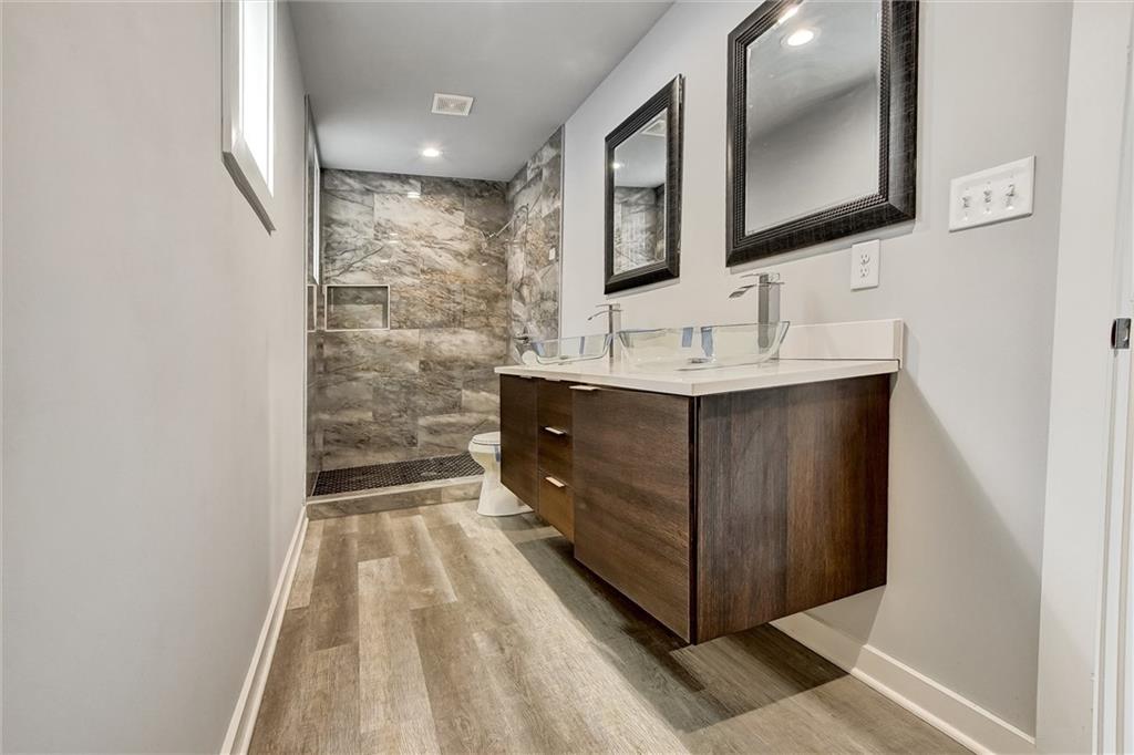 569 Middle Street Southwest Atlanta, GA 30310 - Photo 25 of 35 a bathroom with a sink a mirror and a toilet