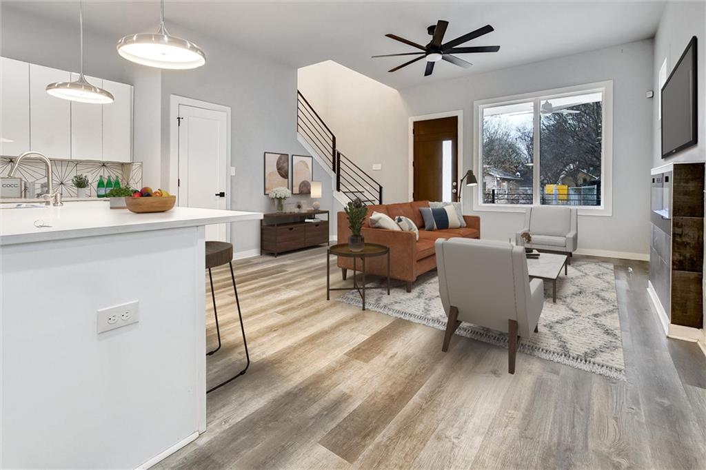 569 Middle Street Southwest Atlanta, GA 30310 - Photo 6 of 35 a living room with furniture a fireplace and a chandelier