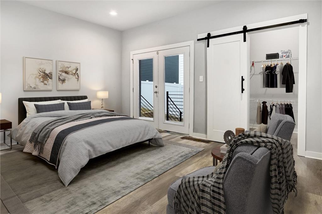 569 Middle Street Southwest Atlanta, GA 30310 - Photo 8 of 35 a bedroom with bed and wooden floor