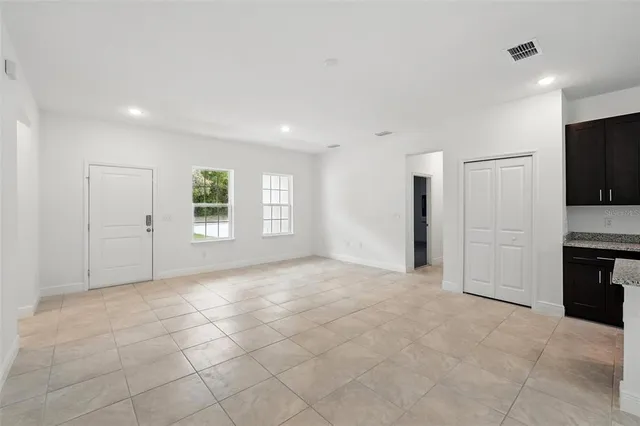 a view of a kitchen with a sink and a refrigerator
