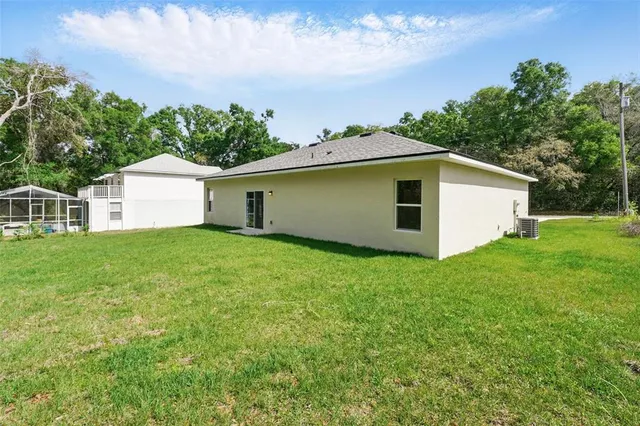 a front view of house with yard and trees