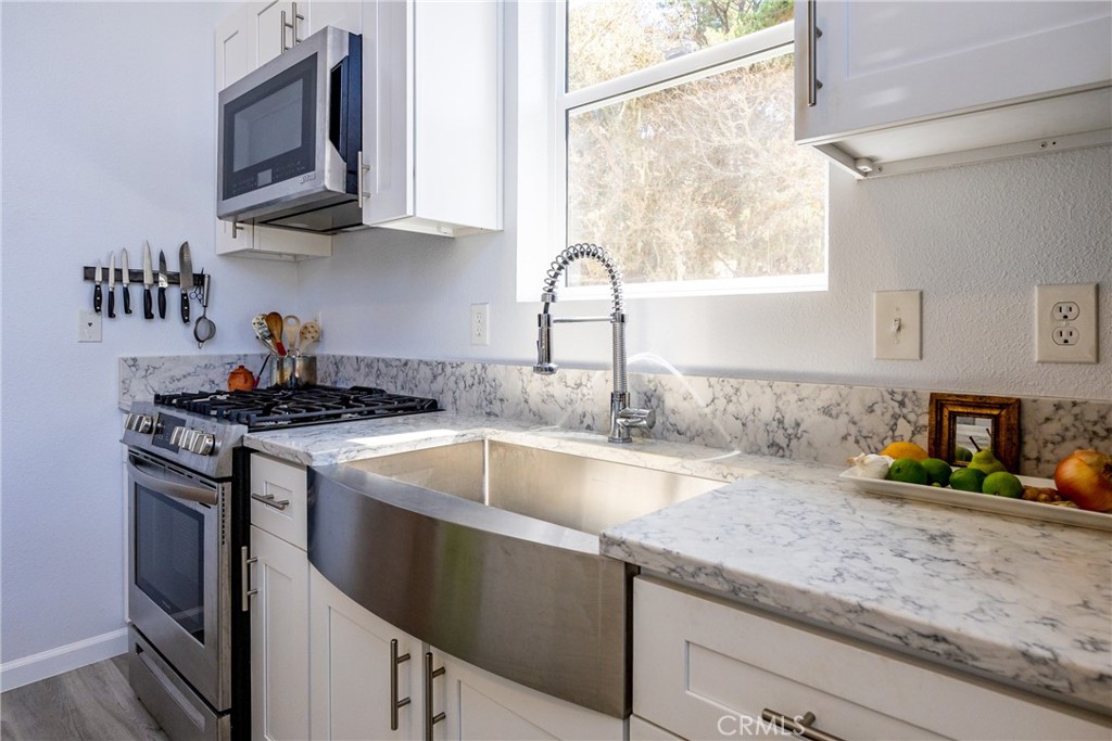 2070 Wales Road Cambria, CA 93428 - Photo 13 of 38 a kitchen with granite countertop a sink stainless steel appliances and cabinets