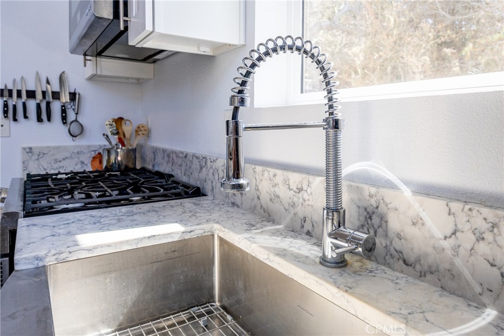 2070 Wales Road Cambria, CA 93428 - Photo 16 of 38 a kitchen with a sink a stove and cabinets
