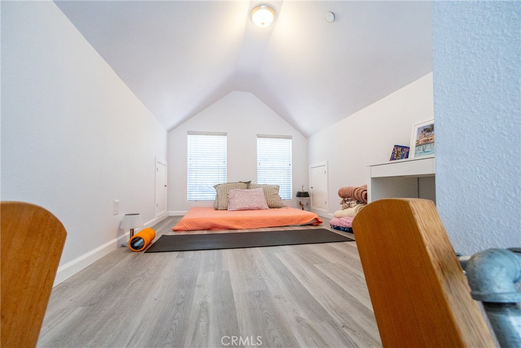 2070 Wales Road Cambria, CA 93428 - Photo 18 of 38 a bedroom with a bed and wooden floor