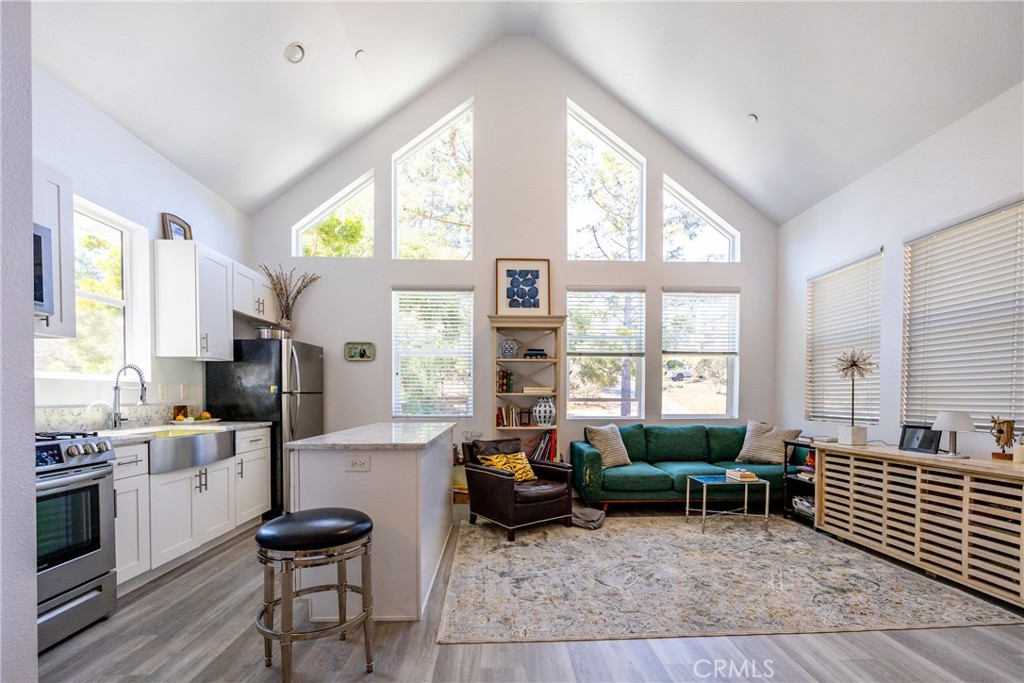 2070 Wales Road Cambria, CA 93428 - Photo 21 of 38 a living room with furniture and large windows