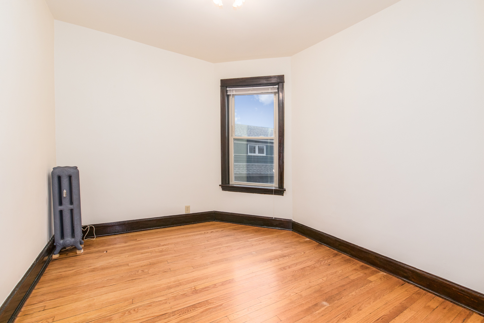 4117 North Paulina Street Chicago, IL 60613 - Photo 15 of 28 a view of an empty room with wooden floor