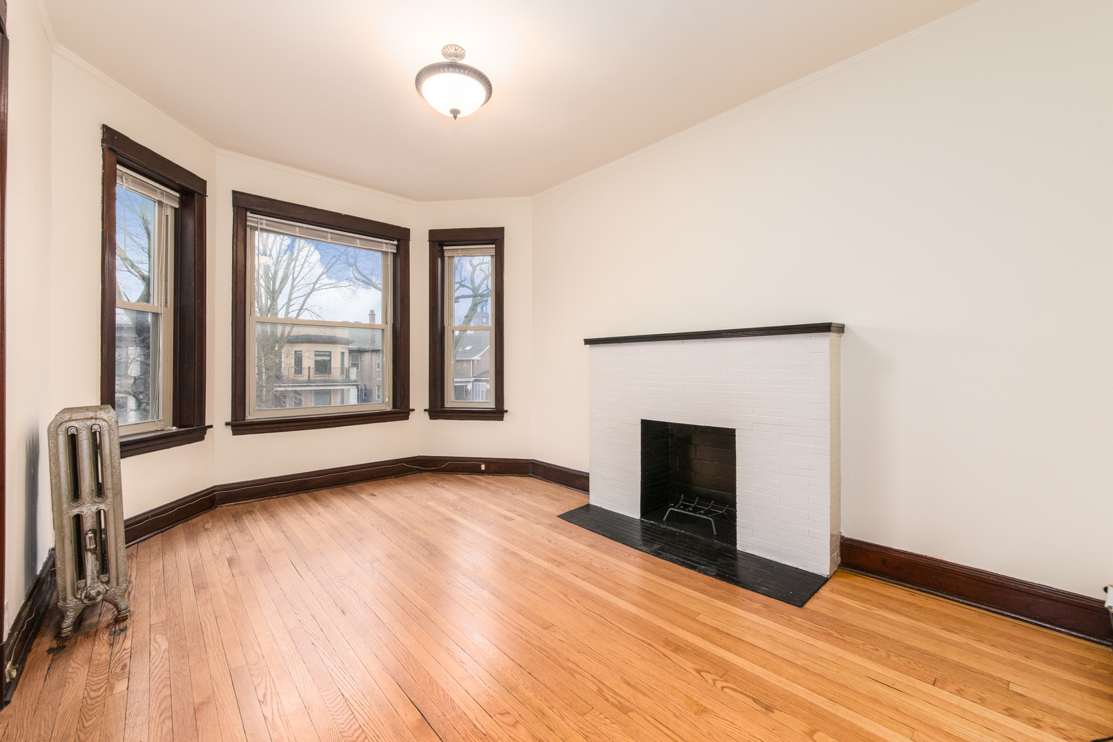 4117 North Paulina Street Chicago, IL 60613 - Photo 18 of 28 an empty room with windows and fireplace