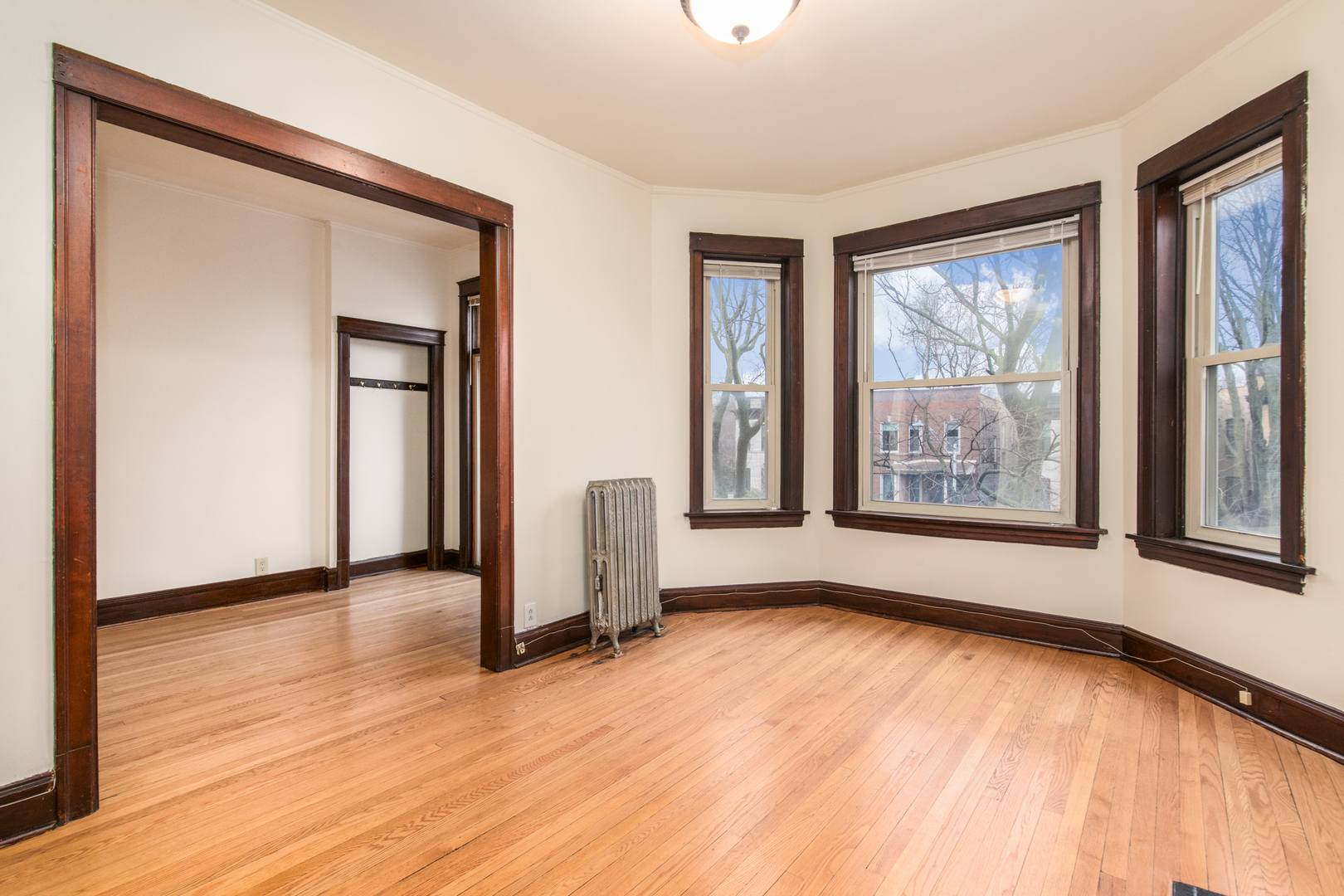 4117 North Paulina Street Chicago, IL 60613 - Photo 19 of 28 wooden floor in an empty room with a window