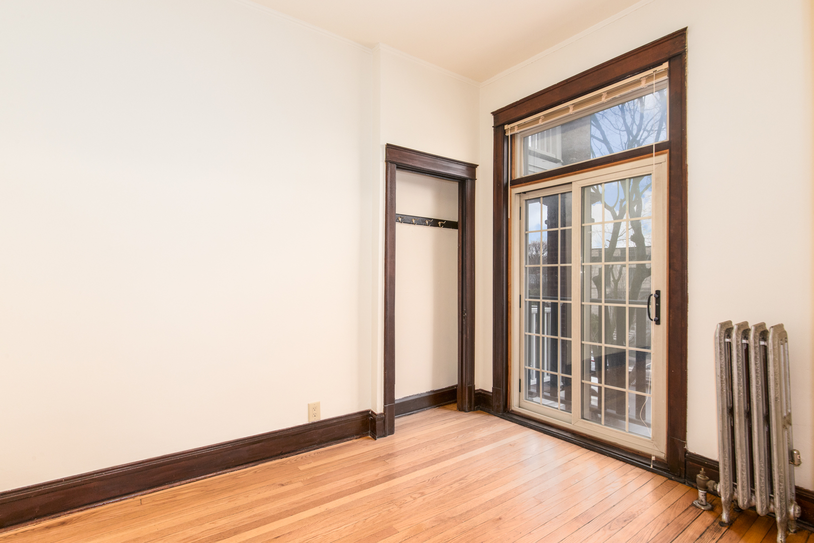 4117 North Paulina Street Chicago, IL 60613 - Photo 20 of 28 a view of an empty room with wooden floor and a window