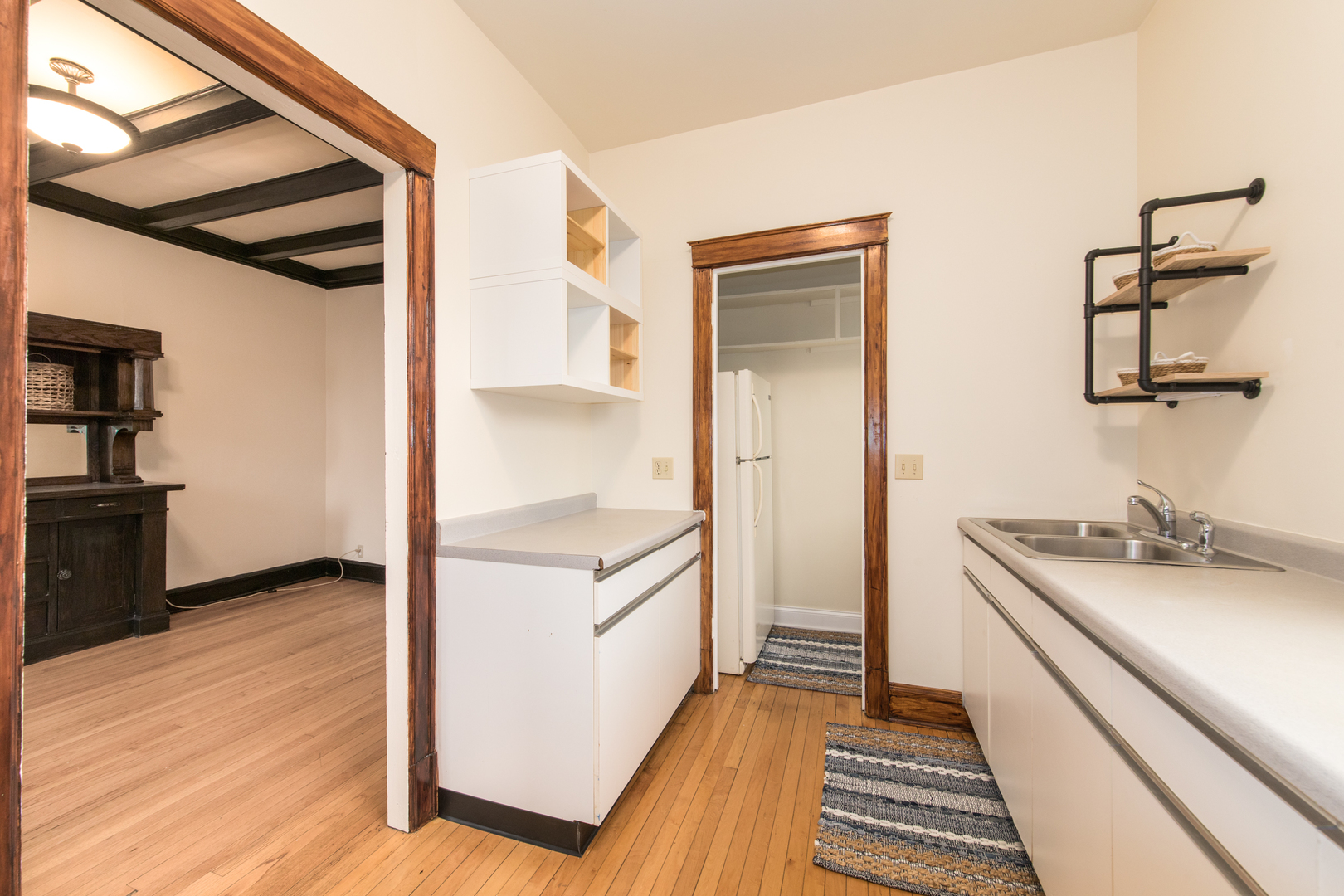 4117 North Paulina Street Chicago, IL 60613 - Photo 10 of 28 a kitchen with a sink and a refrigerator