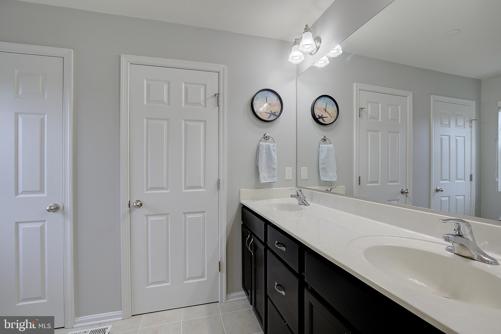 403 Venton Road Edgewater, MD 21037 - Photo 33 of 62 a bathroom with a double vanity sink and a mirror
