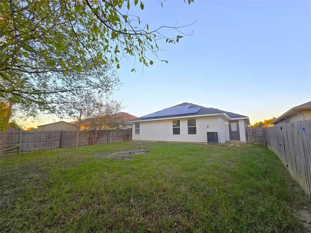 a view of a backyard with large trees
