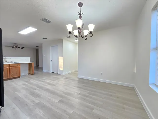 a view of a kitchen with a sink and a chandelier
