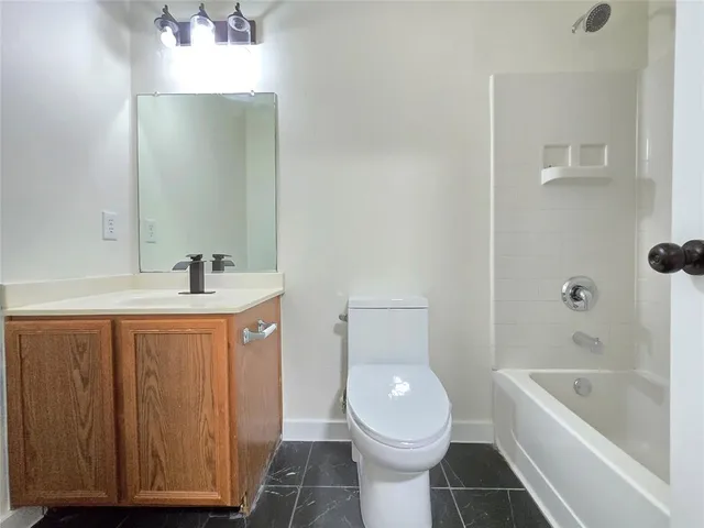 a bathroom with a sink a toilet and bathtub
