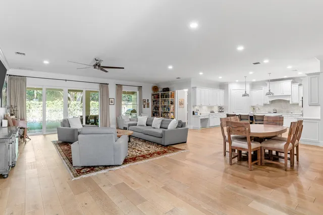 a living room with furniture kitchen view and a fireplace