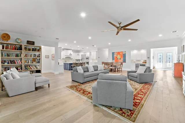 a living room with stainless steel appliances kitchen island granite countertop a dining table chairs and view kitchen