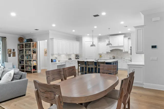 a living room with stainless steel appliances furniture and a kitchen view