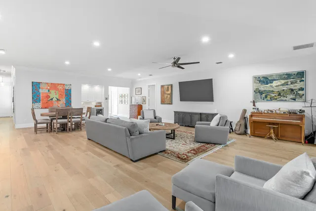 a living room with furniture a rug and a flat screen tv