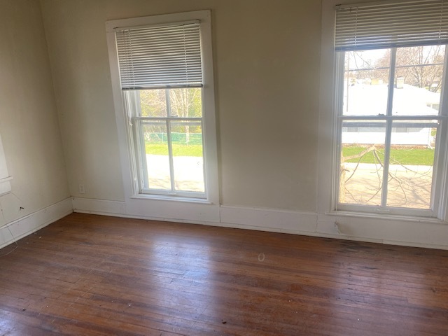 930 North Main Street Rochelle, IL 61068 - Photo 13 of 18 a view of an empty room with wooden floor and a window