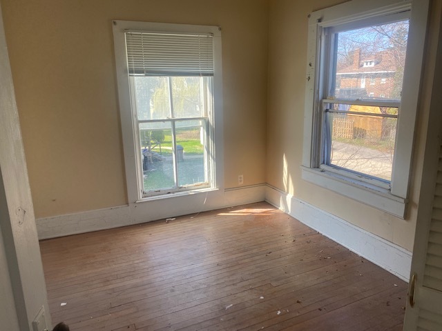 930 North Main Street Rochelle, IL 61068 - Photo 14 of 18 a view of an empty room with wooden floor and a window
