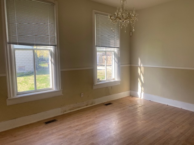930 North Main Street Rochelle, IL 61068 - Photo 7 of 18 an empty room with wooden floor and windows